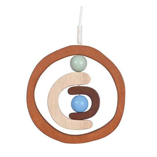 A wooden dream catcher with a circular frame, adorned with a beige and blue spherical ornament, designed as a baby rattle or nursery mobile.
