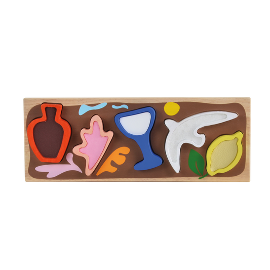 Wooden sensory puzzle with textured and shaped pieces that match illustrated slots on a tray, inspired by modernist art from the French Riviera.