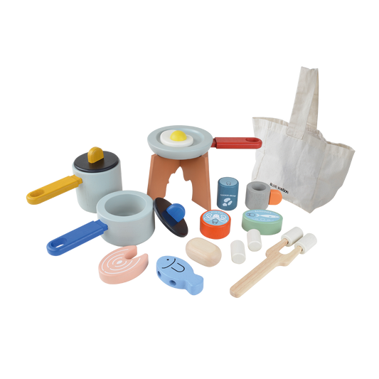 A collection of colorful toy cookware and accessories, including a play tent, fishing game, and utensils, designed for camping role play.