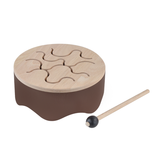 Wooden tongue drum toy producing resonant sounds, promoting auditory skills, imagination, and social development for children 18 months and up.