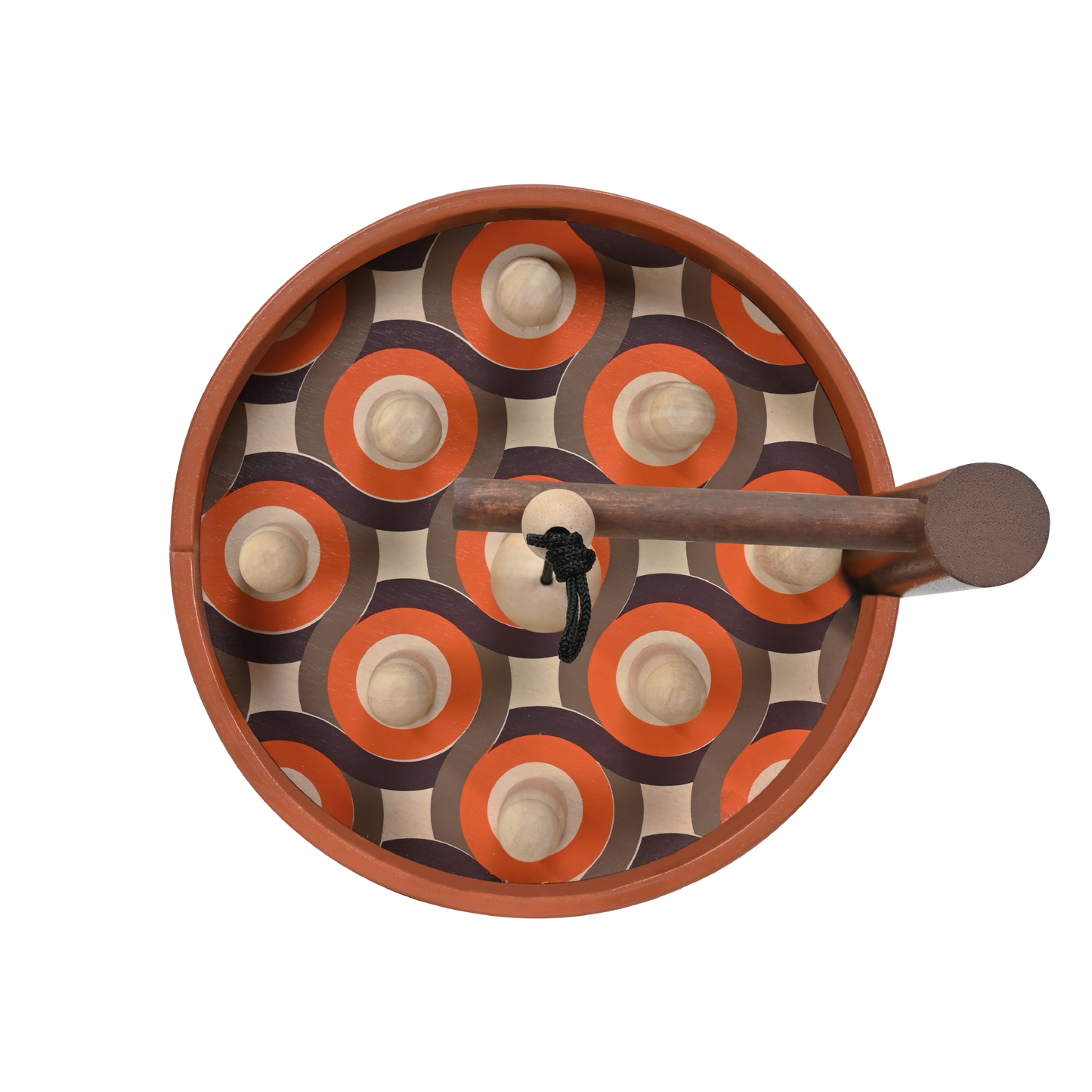 A toy skittle bowling set with a ball and skittles on a brown surface with a wooden frame.