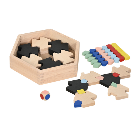 Wooden educational puzzle game with hexagonal box, black and natural wood star-shaped pieces, colorful tokens, and a multicolored dice.