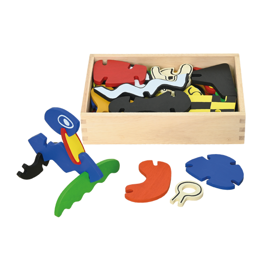A variety of colorful wooden blocks and shapes spilling out of a small wooden box, representing a monster creation construction set.