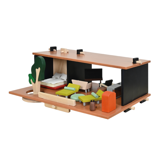 A modern dollhouse with a glass house inspiration, containing modern furniture and minimalist accessories. It is set up with a doll, a cat, and a season change tree.