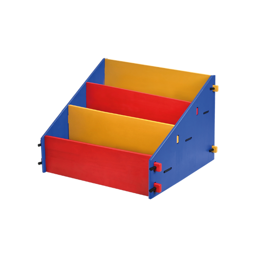 A red, blue, and yellow wooden bookshelf with three slanted compartments designed for children’s books or toys