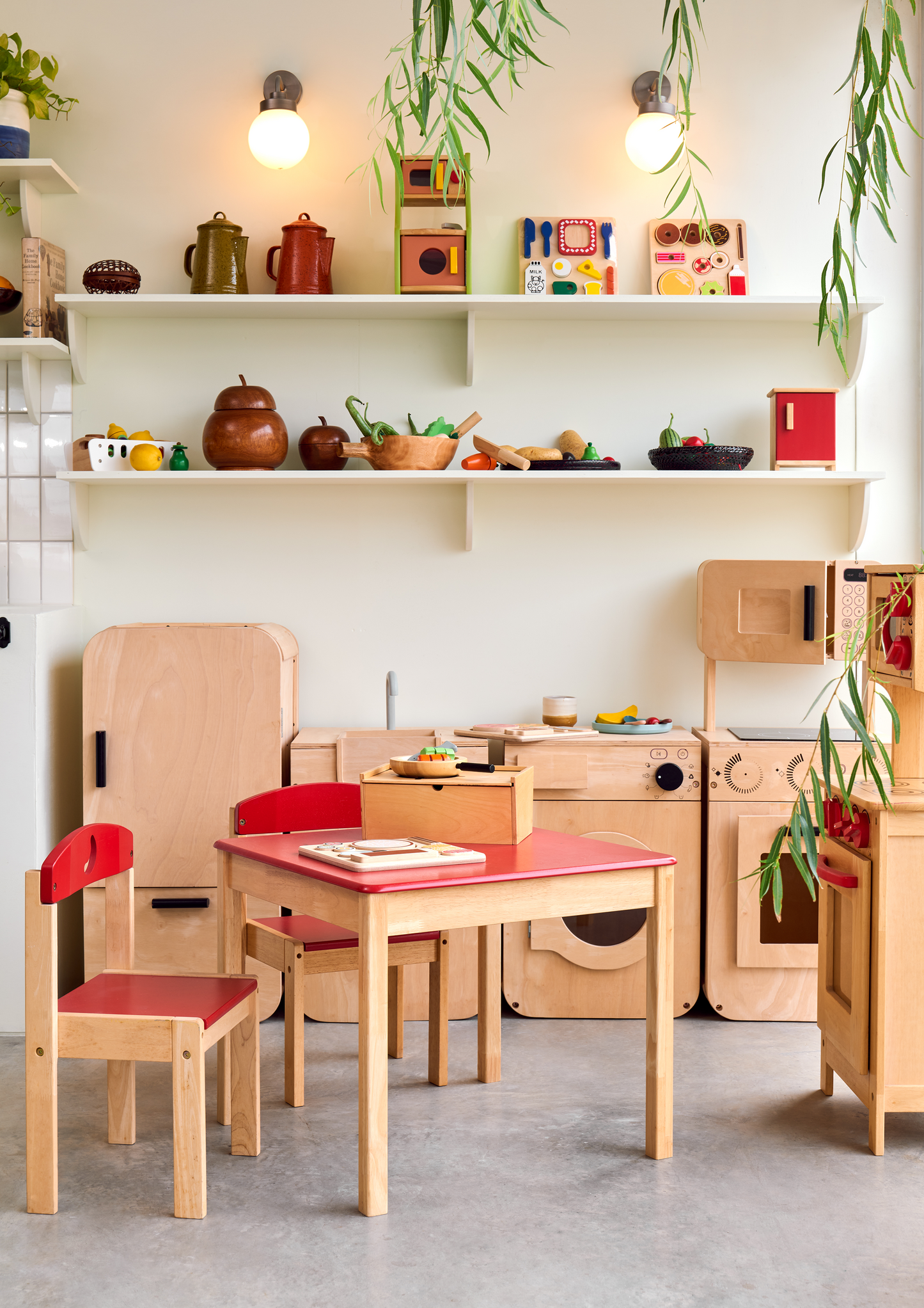Children's wooden kitchen playset with pretend vegetables and kitchen utensils, displayed on a wooden surface.