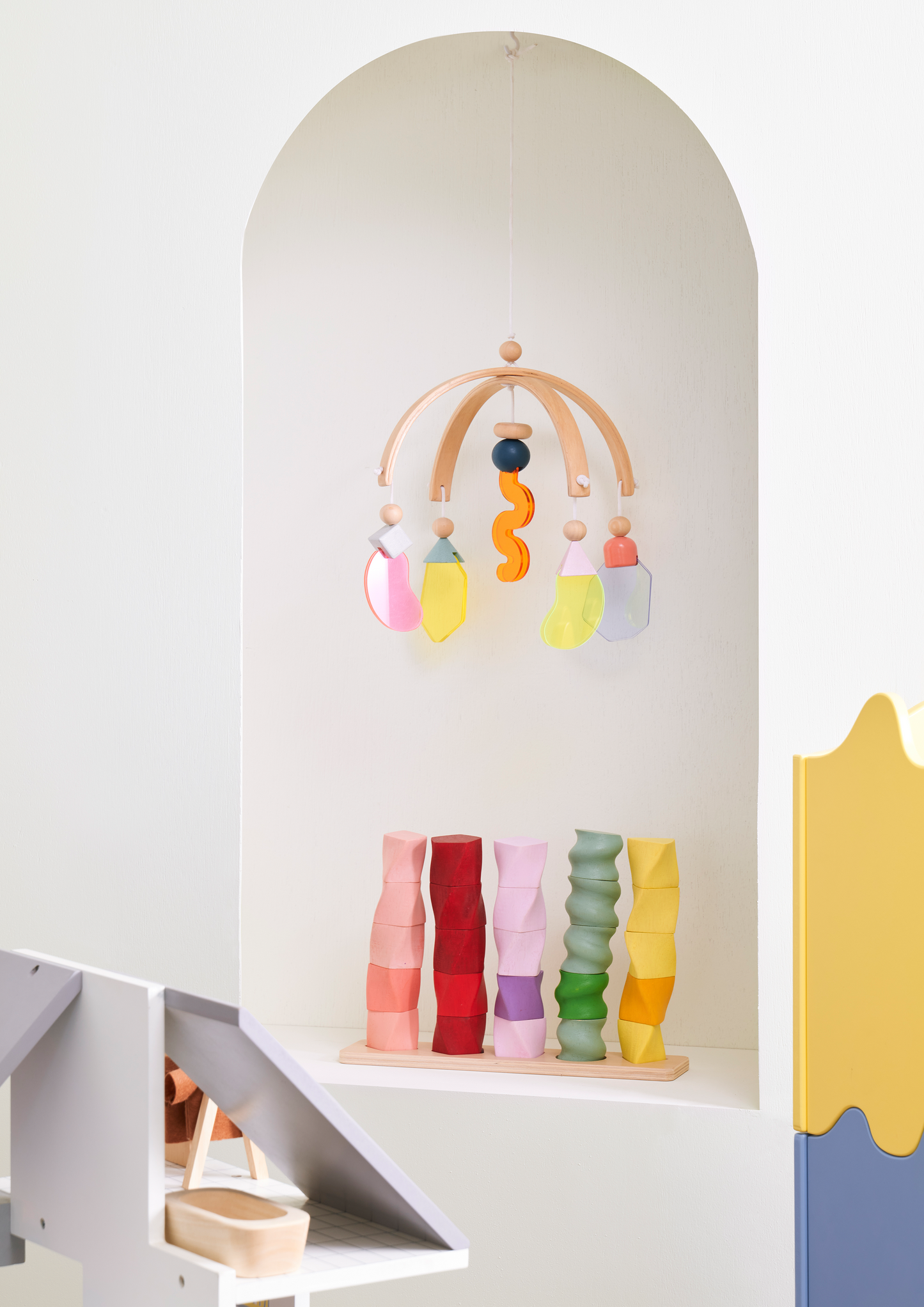 A set of colorful geometric shape sorters in various colors aligned in a row.