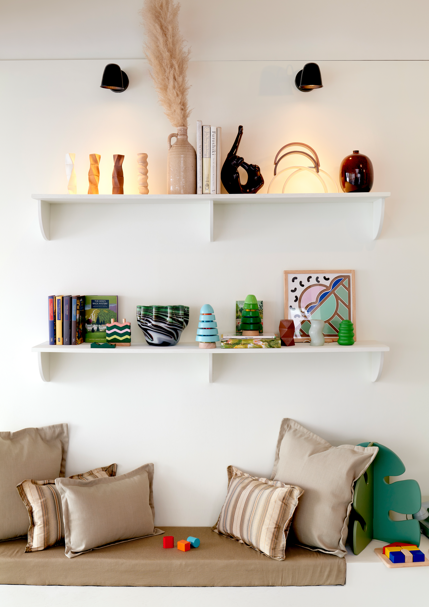 A wooden house-shaped tray puzzle with red, yellow, and blue pieces.