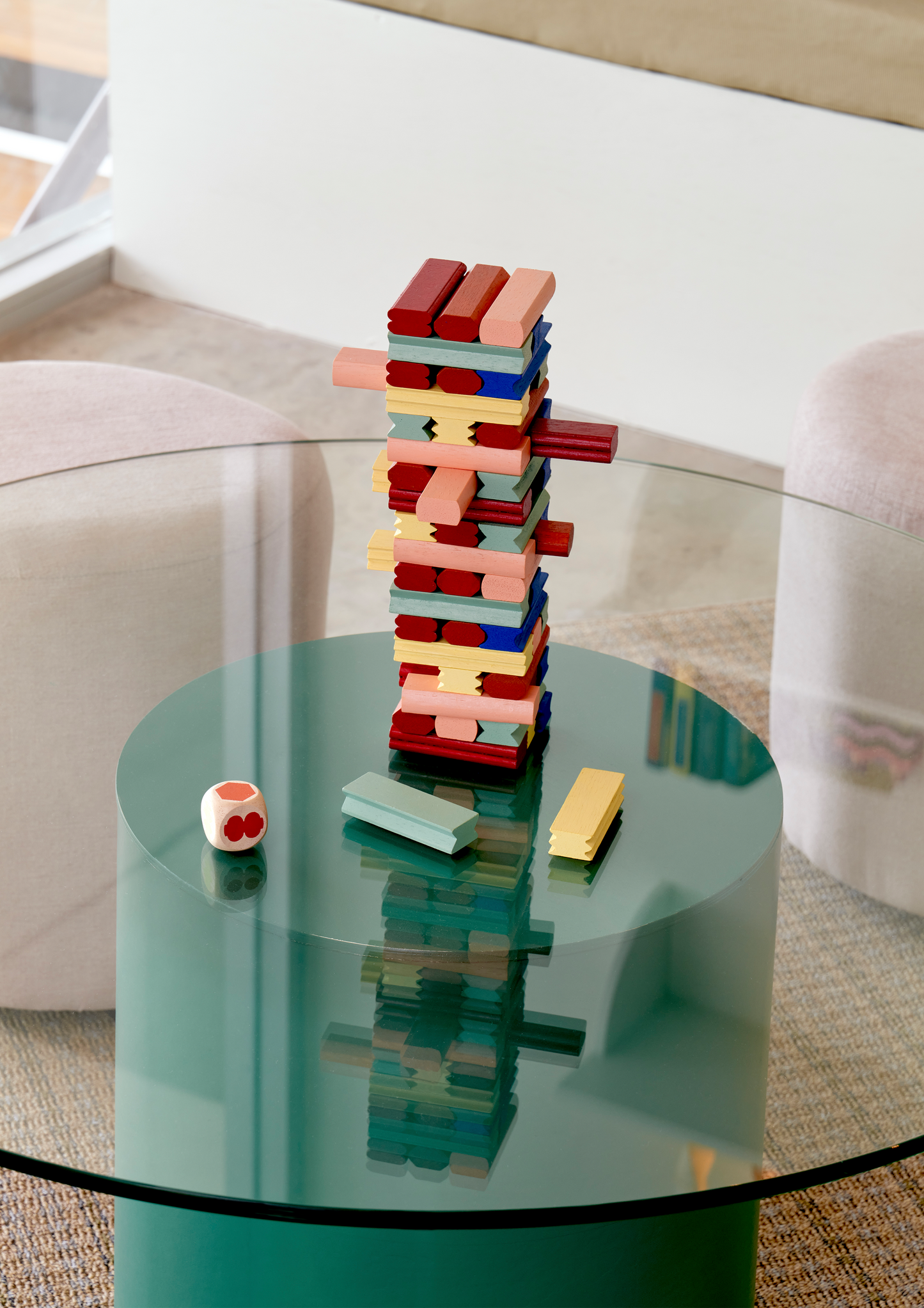 A variety of colorful wooden blocks arranged in a tumbling tower format, with some blocks stacked to form a tower and others spread out on the surface.