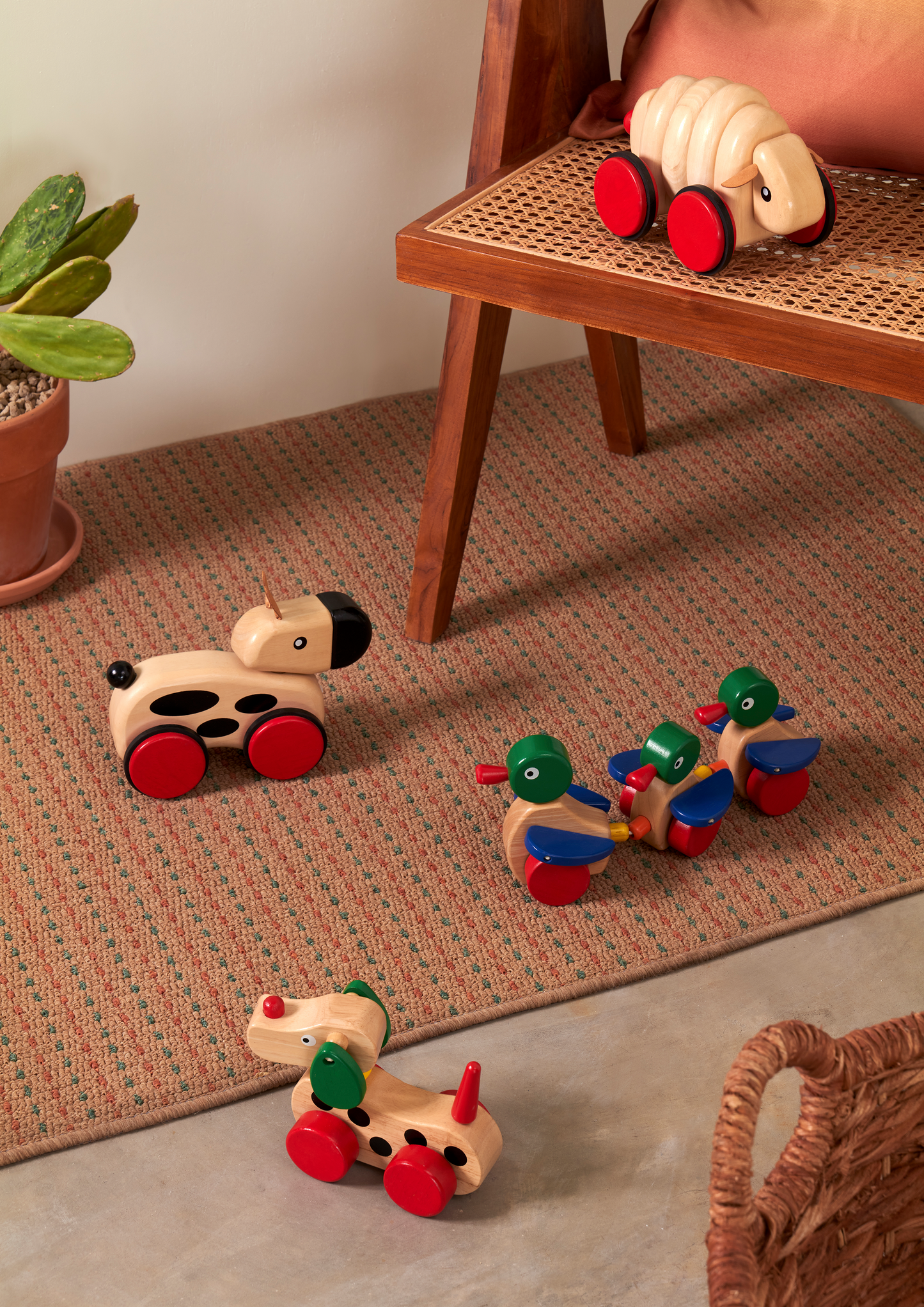 Wooden toy with three ducks on a white background