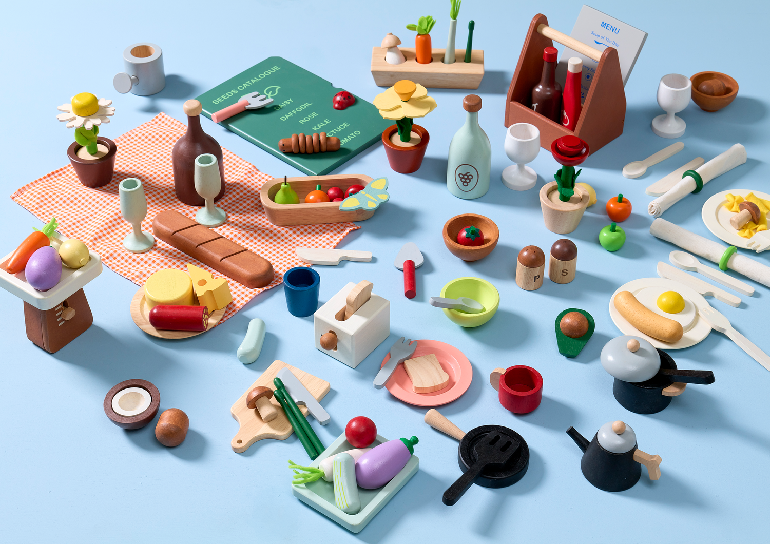 A pretend play restaurant set with wooden table, plastic food items, and wooden utensils.