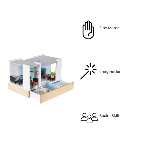 A Mid Century Modern dollhouse with a white and wood facade, featuring a living room with a black sofa, a red armchair, and a blue pendant lamp; a dining area with a wooden table and chairs; and a bedroom with a bed and a wooden headboard.