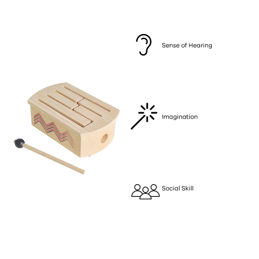 A wooden drum with a beige color, featuring a series of wooden bars and a drum head, accompanied by a wooden mallet.