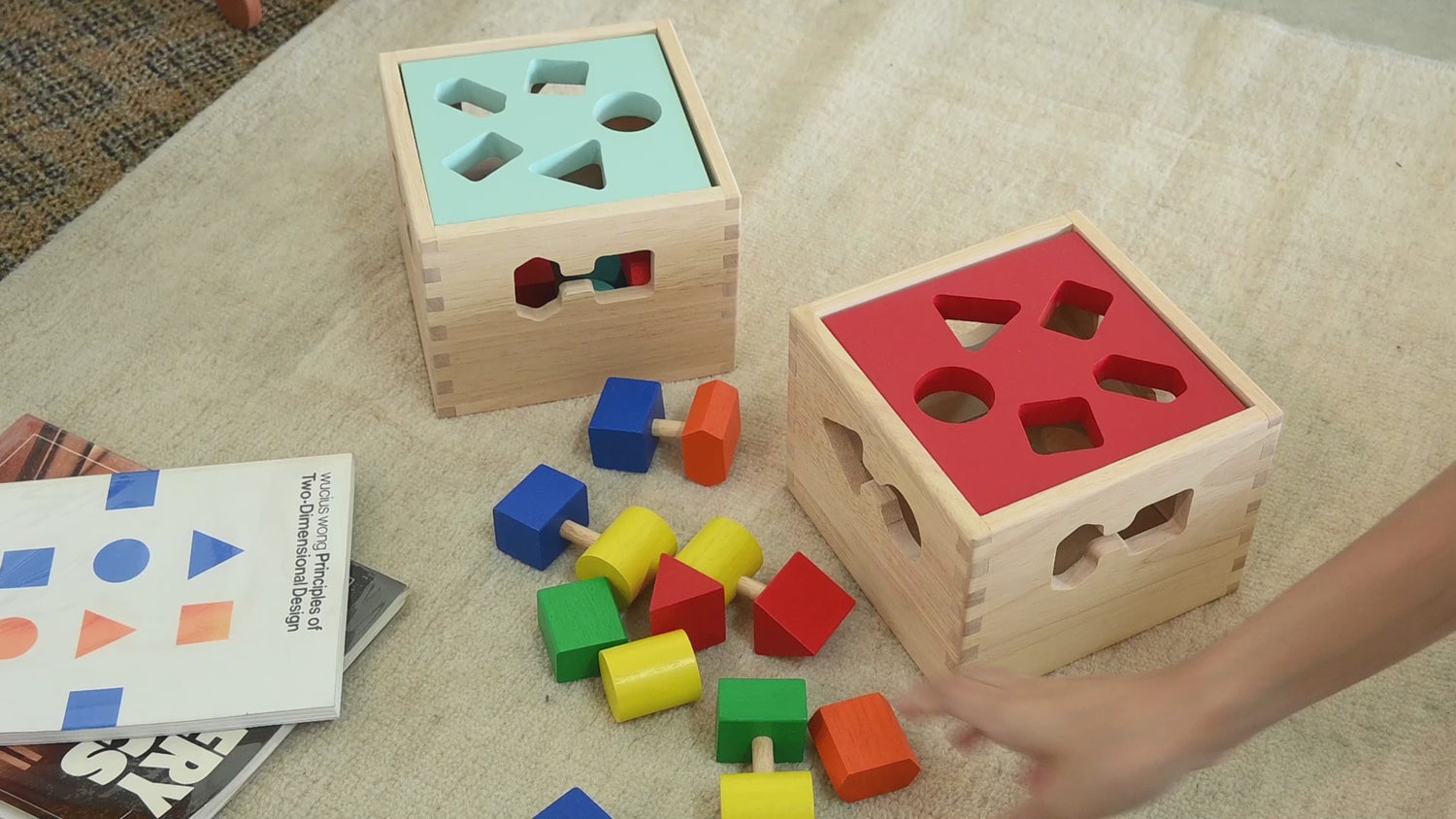 A wooden shape sorter box with various colored blocks inside, designed for young children to sort and match shapes.