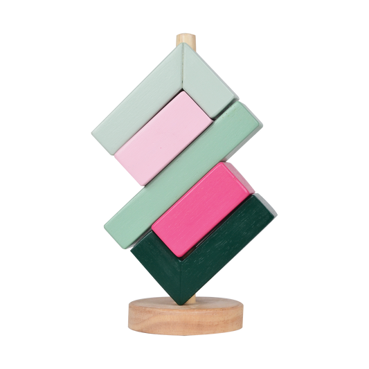 A colorful balance toy consisting of stacked rectangular blocks in shades of green, pink, and blue, arranged in an infinity shape on a wooden rod.
