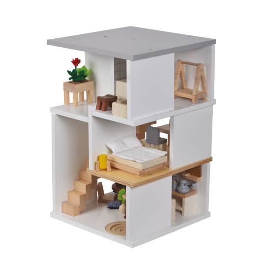 A two-story white dollhouse with furniture and dolls, featuring a modern design with a kitchenette and a bedroom on the upper floor.