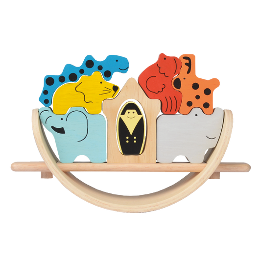 A wooden balance game featuring a boat-shaped board with various animal-shaped pieces and a figure of a person inside the boat.