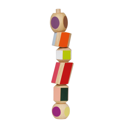 A multicolored totem pole made of wooden blocks, each with a different color and shape, stacked vertically.
