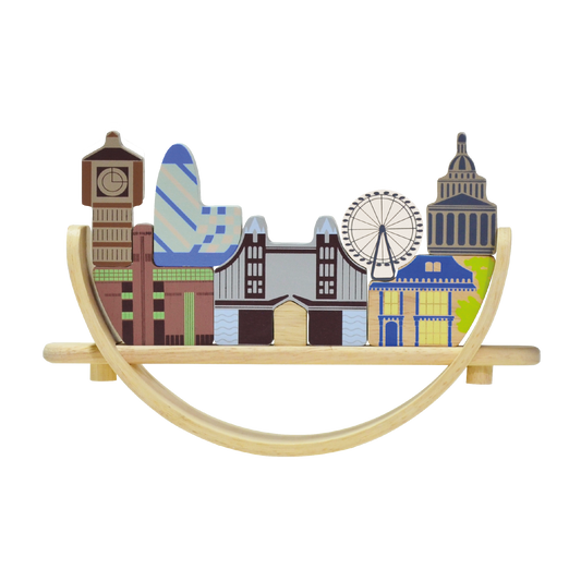 A London cityscape-themed balancing toy featuring famous landmarks. Children can arrange and balance the landmark pieces on a crescent-shaped base that rocks gently with each placement, enhancing coordination and concentration skills.