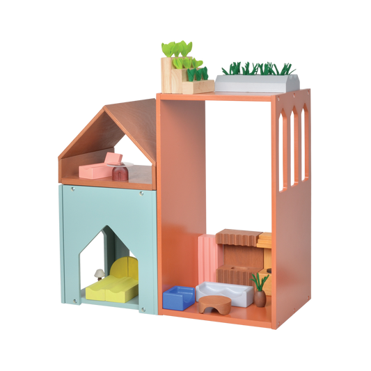 A colorful gable dollhouse with abstract design, featuring a blue house with an orange roof, and an open structure showing furniture and a doll family inside.