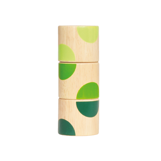A wooden puzzle toy with geometric shapes in green and yellow on a light wooden background.