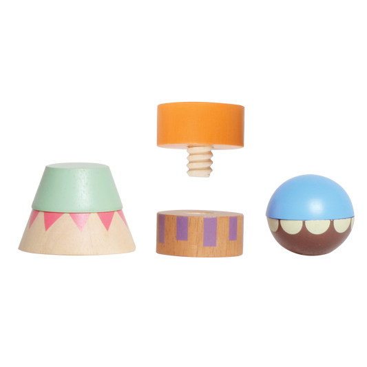 A set of colorful wooden building toys including a red pyramid, a green and blue hat, an orange sphere, and a wooden block.