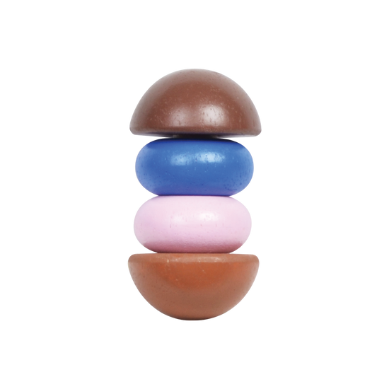 A stack of round rattle caps in brown, blue, and pink colors, designed for infants.