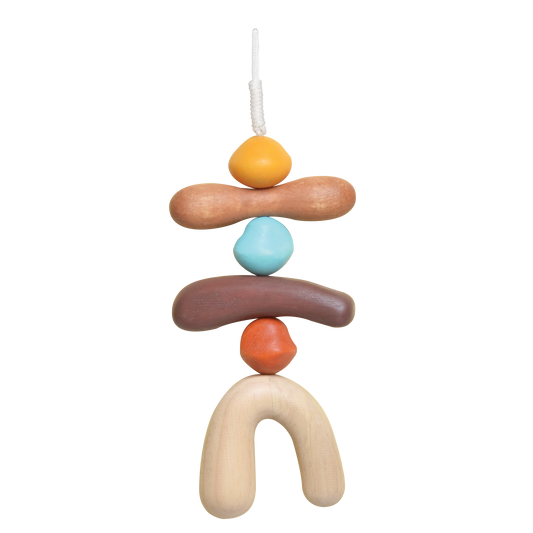 A colorful baby mobile with various geometric shaped hanging elements in shades of blue, orange, brown, and beige.