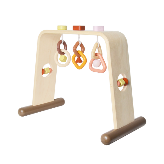 A colorful baby gym with geometric shaped hanging toys, designed for visual and tactile stimulation.