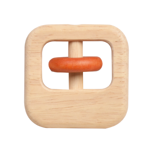 A square-shaped wooden rattle with a natural beige color and a red ring in the center.