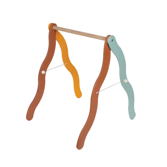 A foldable A-frame mobile hanger with wavy legs in different colors (orange, blue, and brown) designed to be placed over a baby mattress.