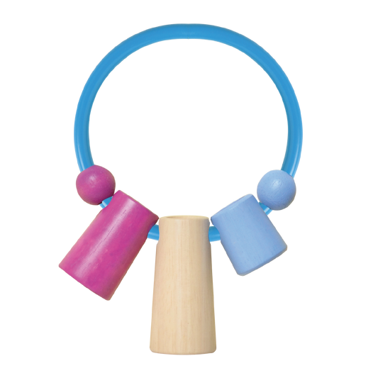 Blue circular rubber musical shaker with three wooden rods in beige, purple, and blue. Encourages children to explore rhythm, differentiate sounds, and develop hand coordination.