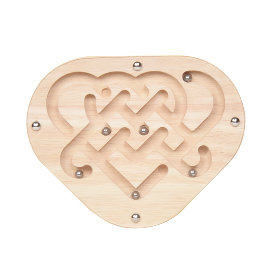 A wooden maze toy with a heart-shaped design and metal balls rolling along the grooved paths.