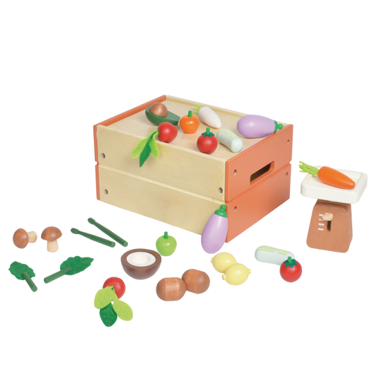 Children's toy farmer's market set with wooden stall and various plastic and wooden food items such as carrots, apples, and mushrooms.