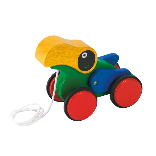A colorful wooden pull-along toy parrot with red, blue, and green body and yellow beak, on wheels with a white pull string.