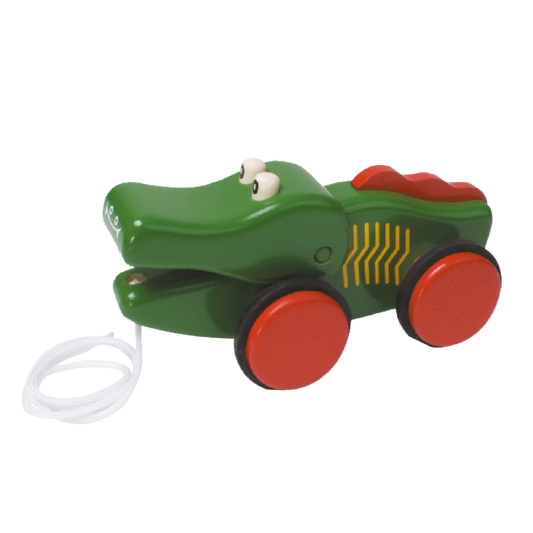 A green crocodile pull toy with red wheels and a white pull string for toddlers.
