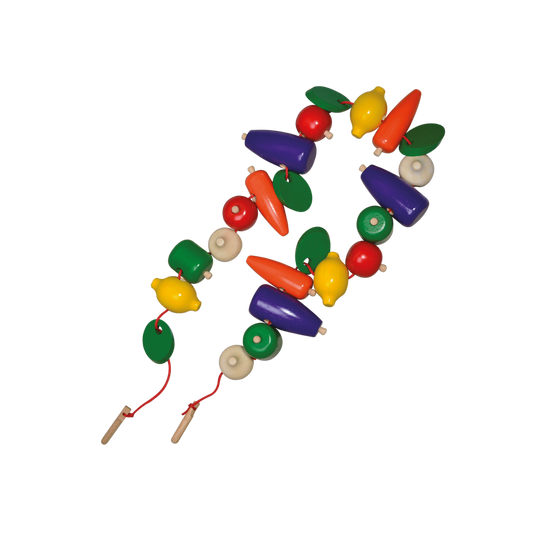 A colorful string of chunky beads in the shapes of vegetables, meant for threading with a wooden needle and cotton string.