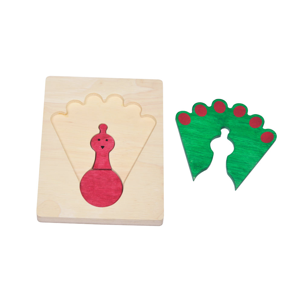 A colorful wooden puzzle shaped like a peacock with a predominantly green and red design on a wooden board.