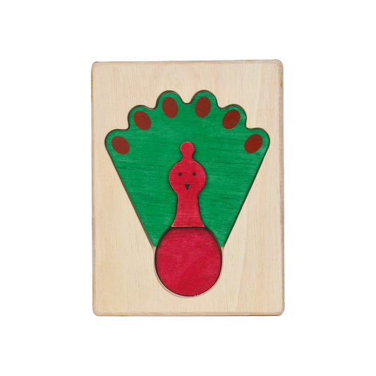 A colorful wooden puzzle shaped like a peacock with a predominantly green and red design on a wooden board.