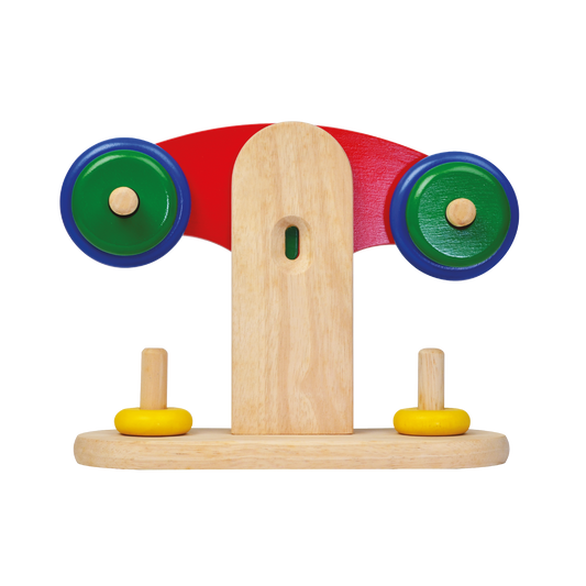 A wooden balance scale toy with colorful discs for children.