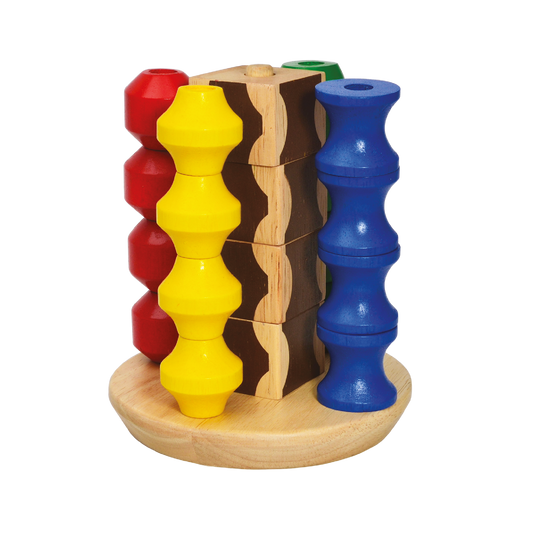 A set of colorful beads in red, yellow, blue, and brown, stacked on a wooden block with a natural finish.