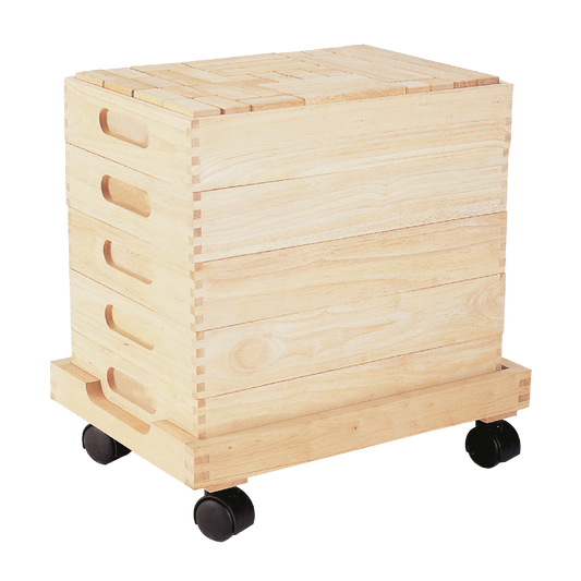 A wooden unit block set on a cart with wheels, containing multiple shapes and sizes of blocks.