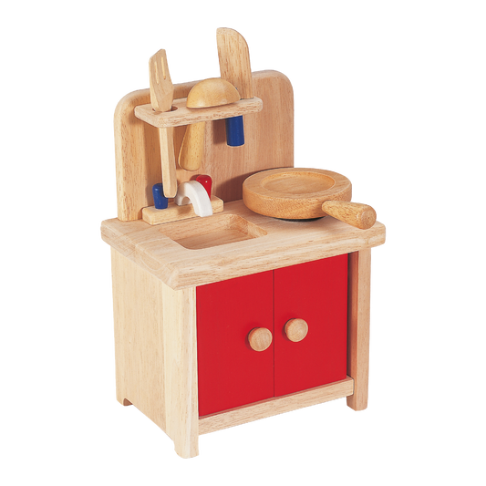 Children's wooden mini kitchenette with red cabinets, a pot, pan, and various utensils.