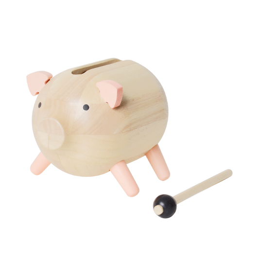 A wooden piglet-shaped slit drum with a cylindrical body and a small wooden mallet.