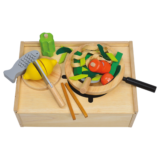 Children's wooden kitchen playset with pretend vegetables and kitchen utensils, displayed on a wooden surface.