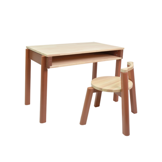 A simple wooden desk and chair set for children, with the desk positioned to the left and the chair to the right, both with natural wood finishes.