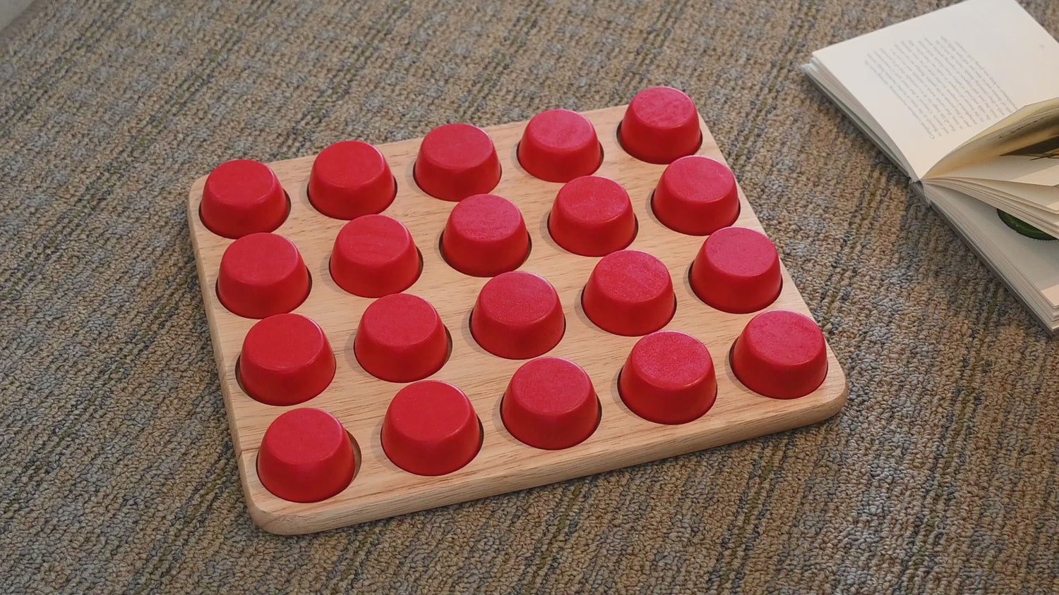 Colorful beads with caps, arranged so identical pairs are never in the same place, promoting shape recognition and memory skills.